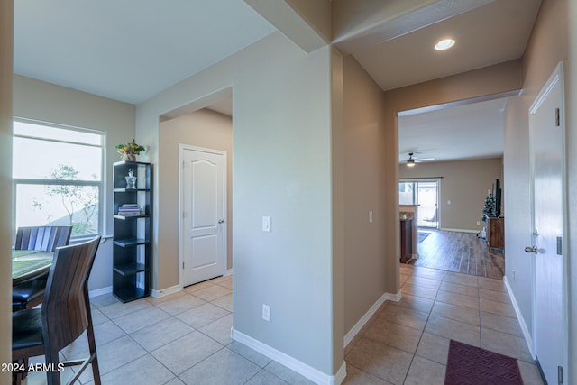 tiled office space featuring ceiling fan