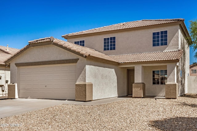 mediterranean / spanish home featuring a tile roof, an attached garage, concrete driveway, and stucco siding