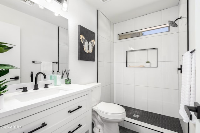 full bath featuring toilet, visible vents, vanity, and tiled shower