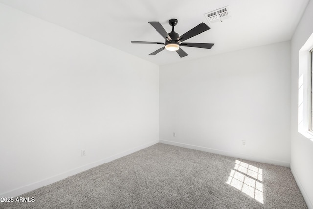 carpeted empty room featuring baseboards, a ceiling fan, and visible vents