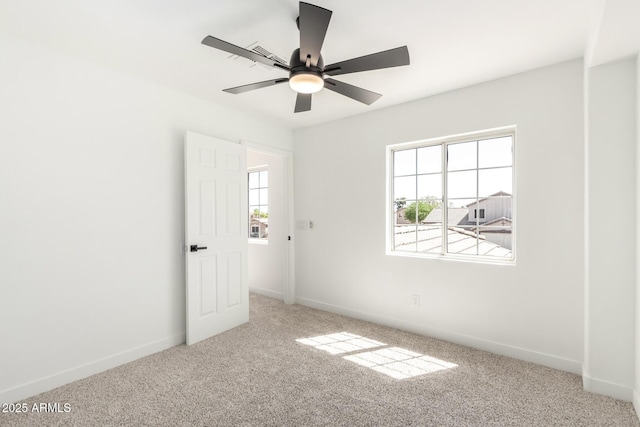 unfurnished bedroom with carpet floors, multiple windows, and baseboards