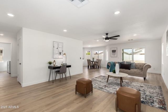 living area featuring recessed lighting, visible vents, light wood finished floors, and baseboards