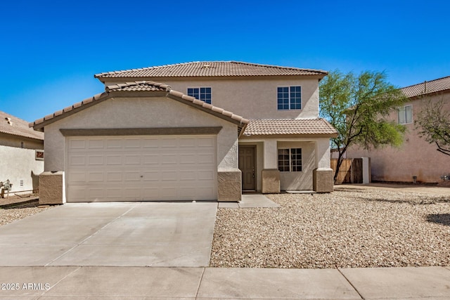 traditional-style house featuring an attached garage, a tile roof, stucco siding, and driveway