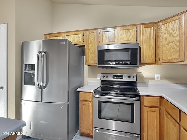 kitchen with stainless steel appliances and vaulted ceiling