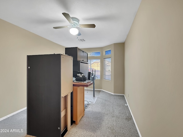 carpeted office space with ceiling fan