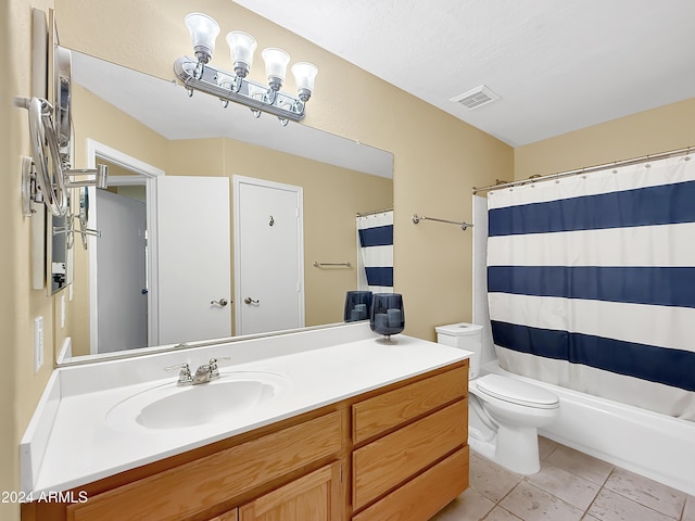 bathroom featuring toilet, vanity, and tile patterned floors