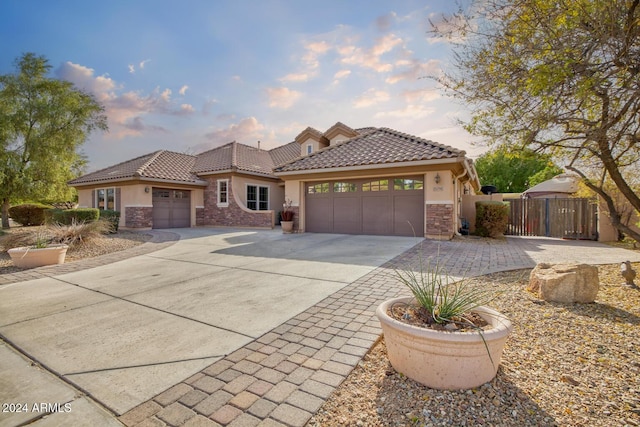 mediterranean / spanish-style home with a garage