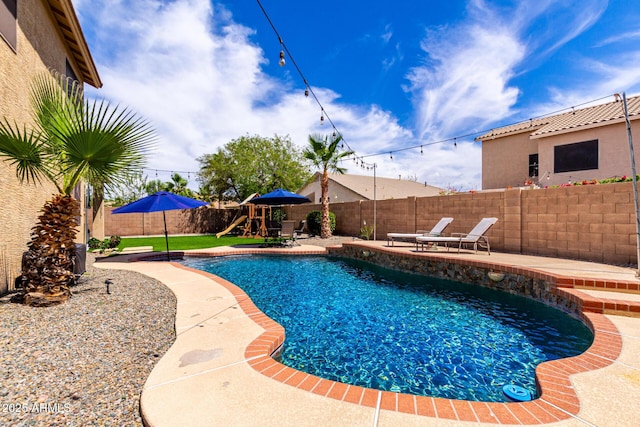 16565 W Garfield St, Goodyear, AZ 85338 - view of swimming pool with a playground, a fenced backyard, and a patio