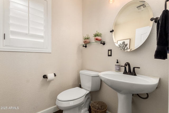 16565 W Garfield St, Goodyear, AZ 85338 - bathroom featuring toilet, baseboards, and a sink
