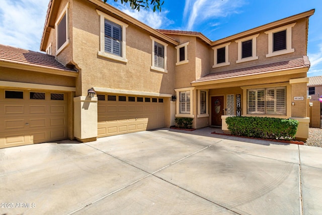 16565 W Garfield St, Goodyear, AZ 85338 - view of front of home with a tiled roof, stucco siding, concrete driveway, and an attached garage