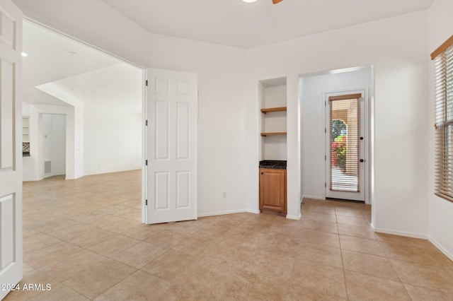 unfurnished living room with light tile patterned floors