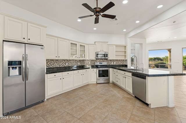 kitchen featuring sink, ceiling fan, tasteful backsplash, white cabinetry, and stainless steel appliances