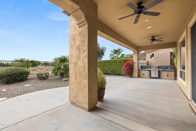 view of patio featuring area for grilling and ceiling fan