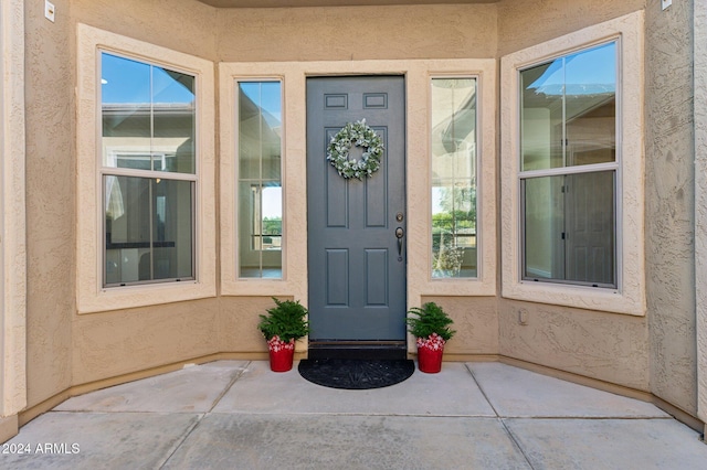 property entrance featuring a patio area