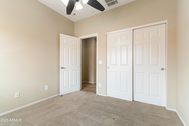 unfurnished bedroom featuring a closet, visible vents, baseboards, and carpet