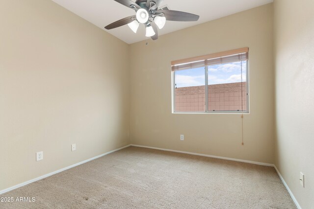 spare room with a ceiling fan, baseboards, and carpet floors