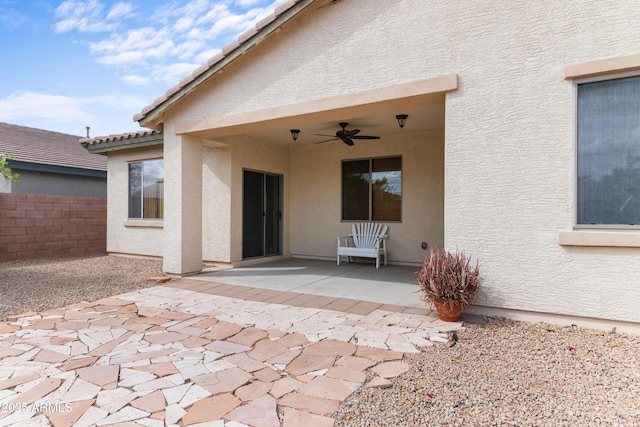 view of patio with a ceiling fan and fence