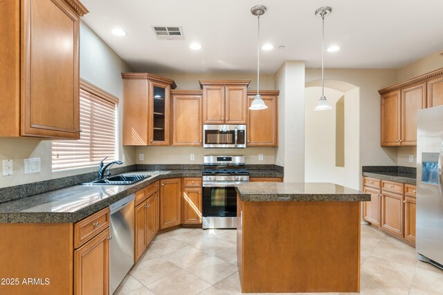 kitchen featuring a sink, dark countertops, visible vents, and stainless steel appliances