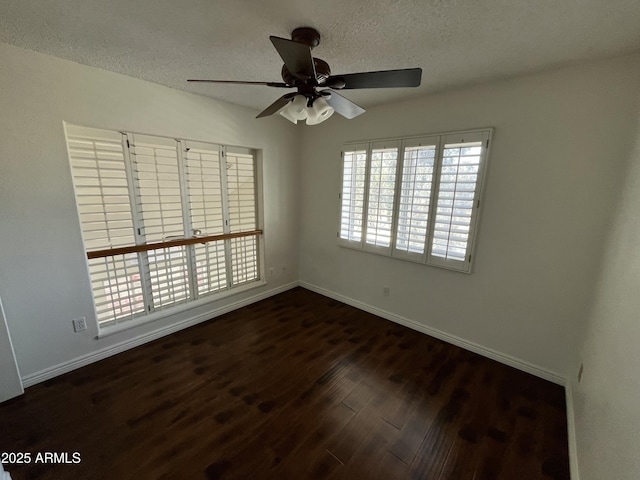 unfurnished room featuring a textured ceiling, ceiling fan, and dark wood-type flooring