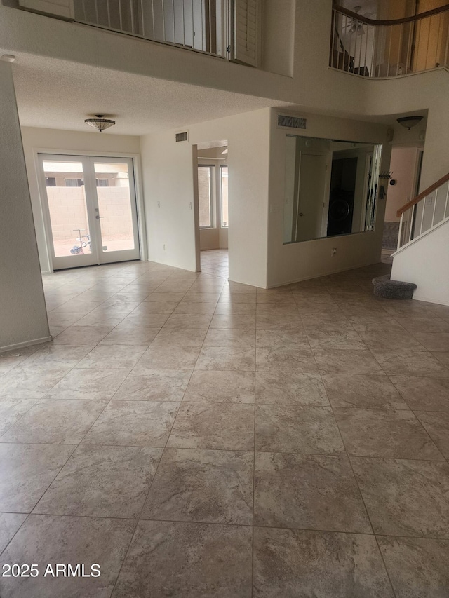 unfurnished room featuring french doors