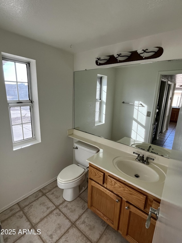 bathroom featuring tile patterned floors, vanity, and toilet