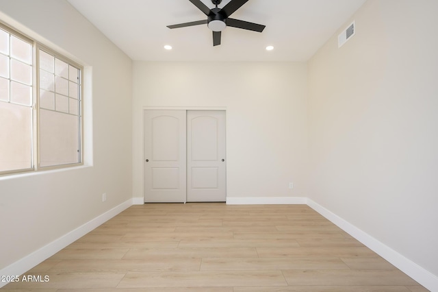 empty room featuring ceiling fan and light hardwood / wood-style floors