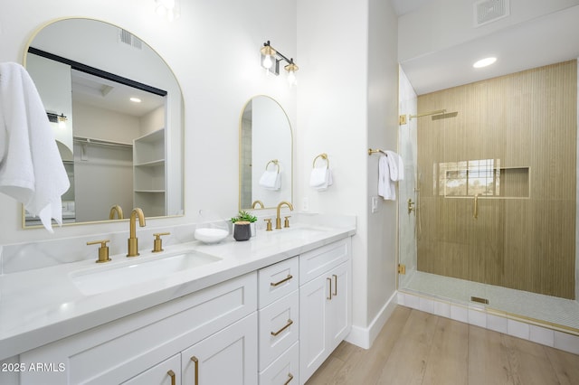 bathroom featuring vanity, hardwood / wood-style floors, and an enclosed shower