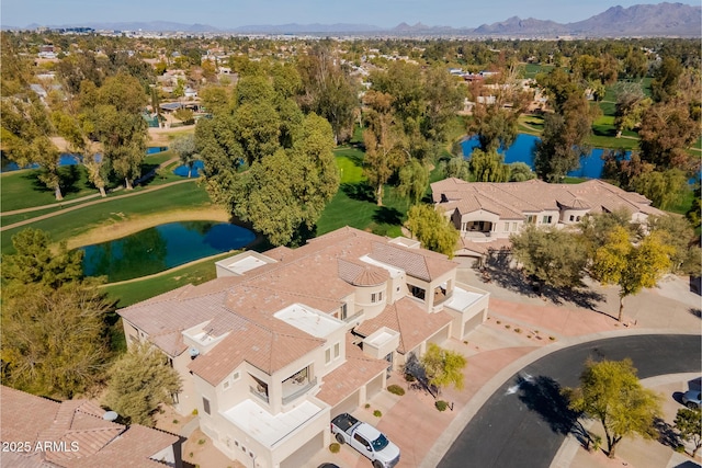 birds eye view of property with a water and mountain view