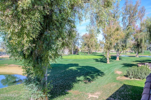 view of property's community featuring a yard and a water view