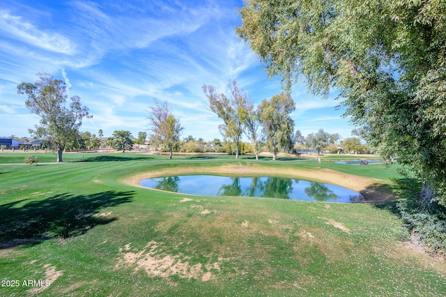 view of property's community with a lawn and a water view