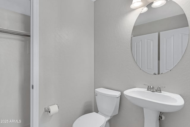 bathroom featuring sink and toilet