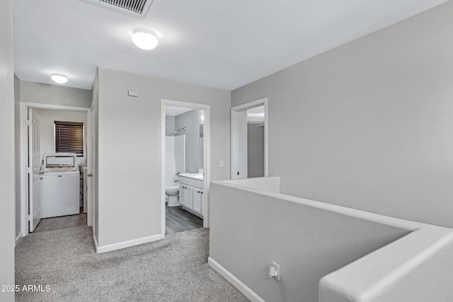 hallway featuring washer / clothes dryer and carpet