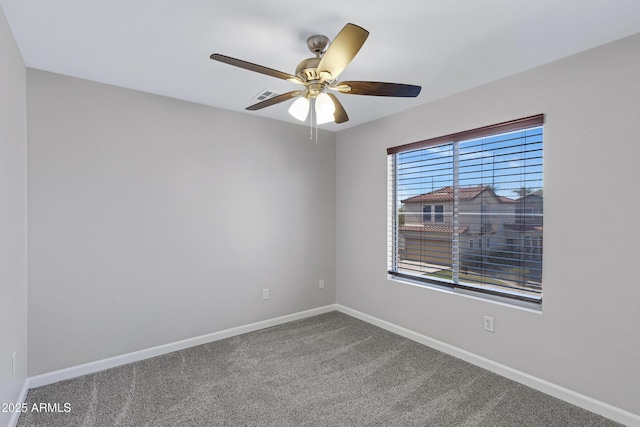 carpeted spare room with ceiling fan