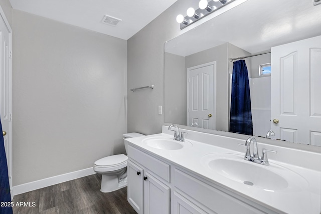 bathroom with vanity, hardwood / wood-style floors, curtained shower, and toilet