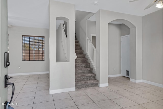 foyer entrance featuring ceiling fan and light tile patterned flooring