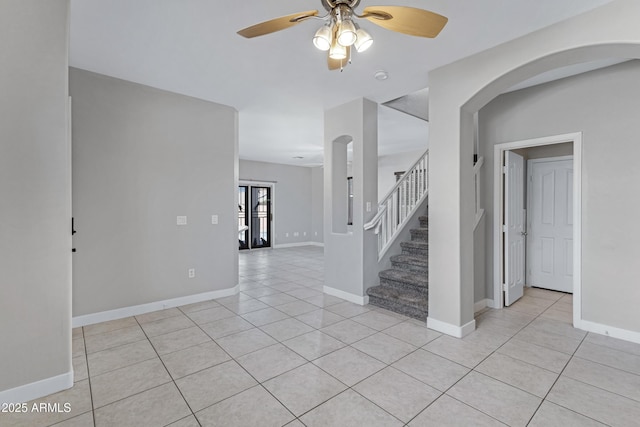 interior space featuring light tile patterned floors and ceiling fan