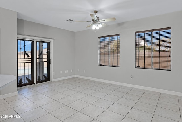 unfurnished room with light tile patterned floors and ceiling fan