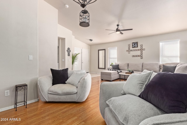 living room featuring wood-type flooring, lofted ceiling, and ceiling fan