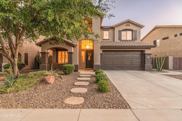 mediterranean / spanish-style home with a garage