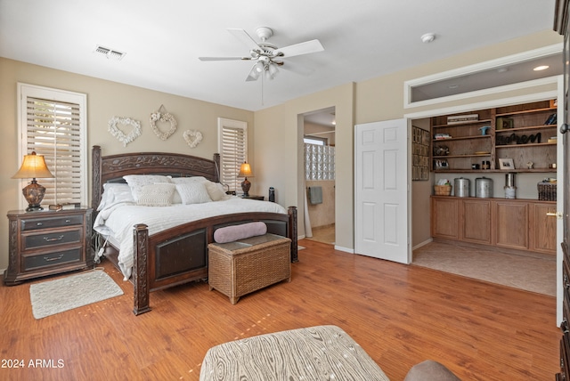 bedroom with light hardwood / wood-style flooring and ceiling fan