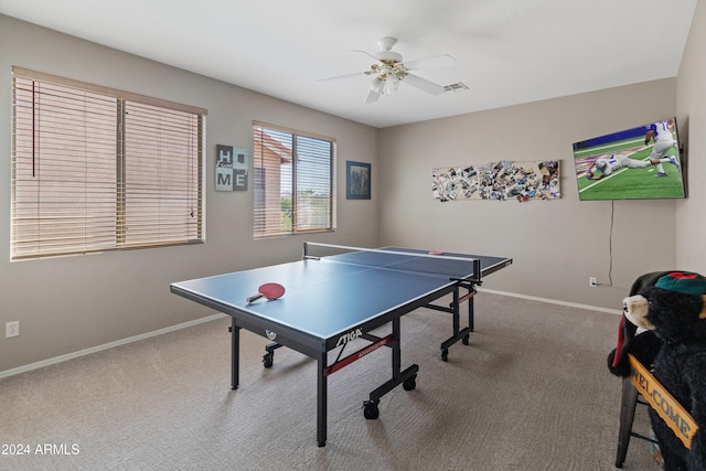 recreation room with ceiling fan and carpet