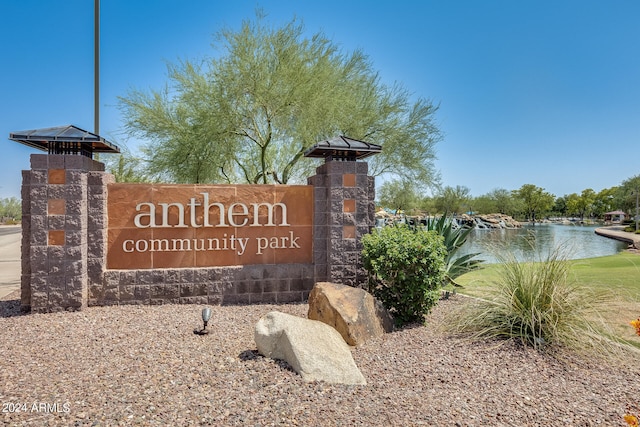 community sign featuring a water view