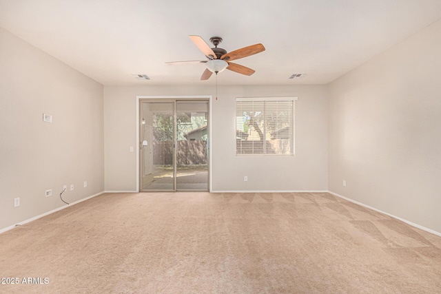 unfurnished room featuring light carpet, baseboards, a ceiling fan, and visible vents