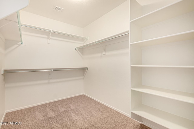 spacious closet with visible vents and carpet flooring