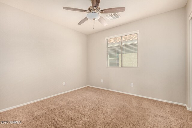 empty room with visible vents, ceiling fan, carpet flooring, and baseboards