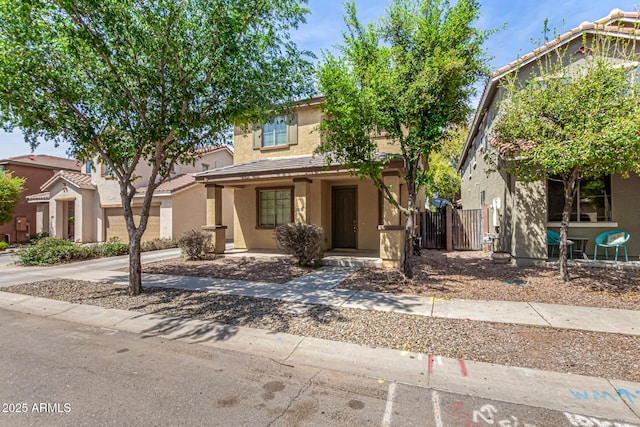 view of front of property with a tiled roof, fence, and stucco siding