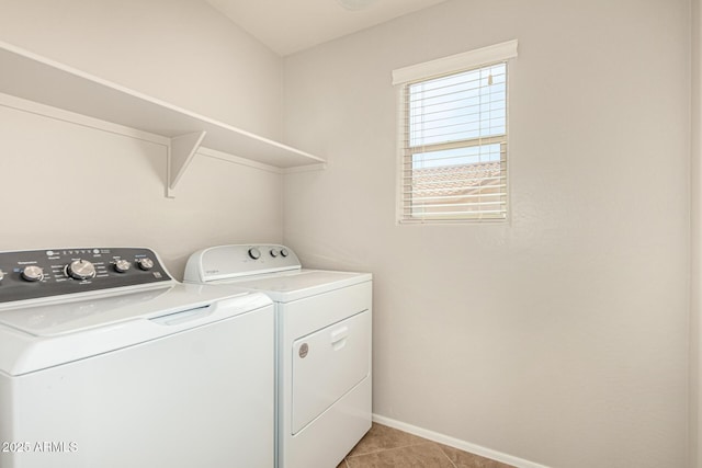 laundry room with independent washer and dryer, laundry area, light tile patterned floors, and baseboards