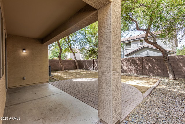 view of patio with a fenced backyard and central AC