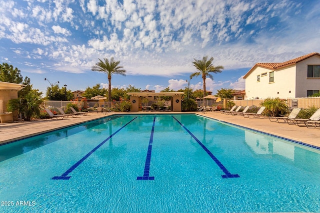 community pool featuring a patio and fence