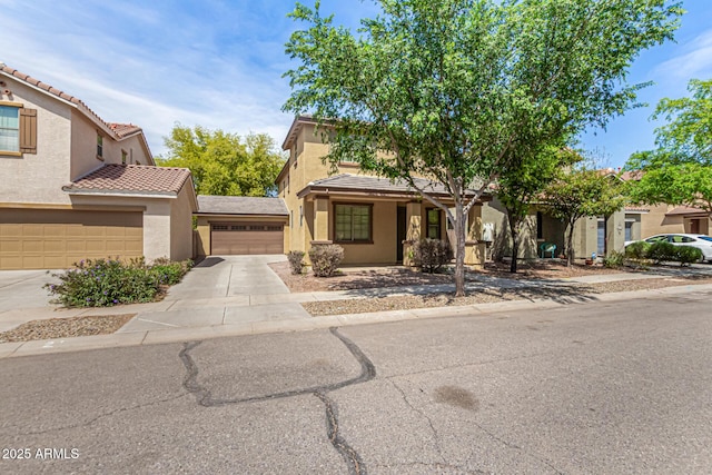 view of front facade featuring concrete driveway, stucco siding, an attached garage, and a tile roof